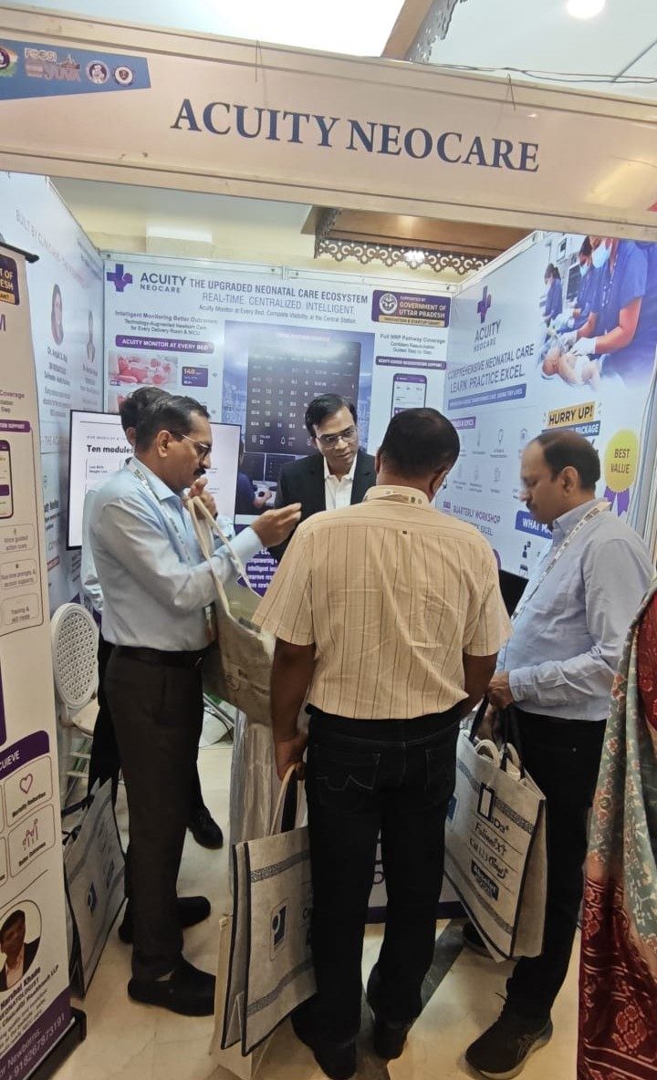A group of delegates in discussion at the Acuity Neocare stall